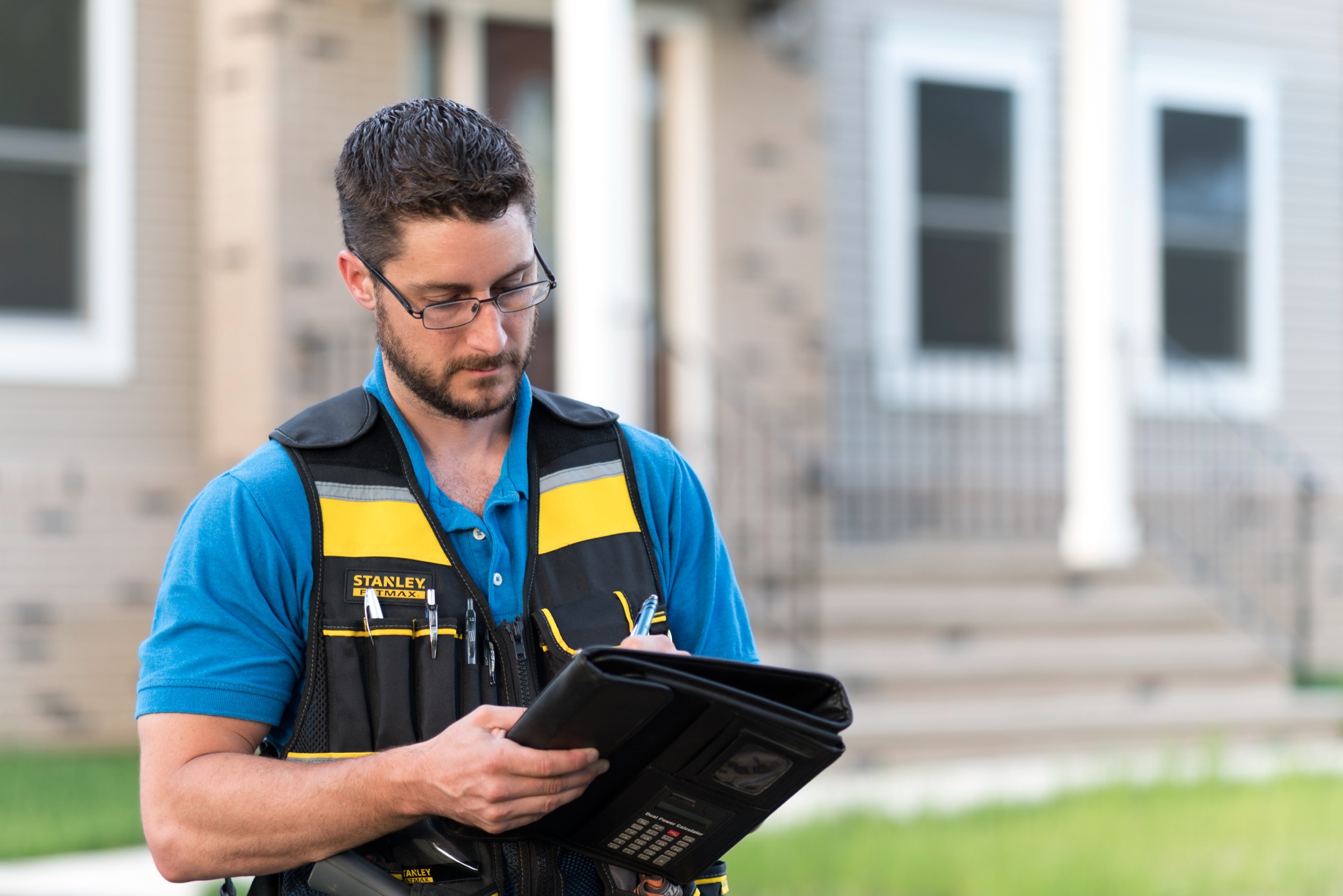 Mike Seltzer writing notes during a home inspection